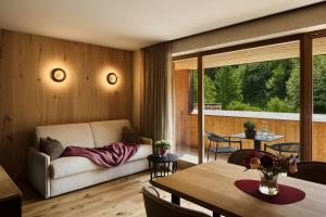 a living room with a couch and a table at Chalet Vanzi in San Martino in Badia