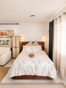 a bedroom with a large bed with a basket on it at Spacious Studio w Pool, Gym, Smart Lock, Netflix in Puerto Princesa City +64 photos