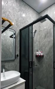 a bathroom with a shower and a sink at Caspian Deluxe Apart Hotel in Aktau