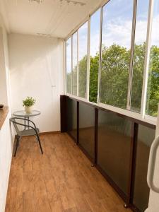 an empty room with a table and windows at Apartnám Harmony in Martin