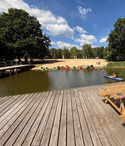 a group of kayaks on the water next to a dock at Lawendowa Ostoja - dom na wyłączność in Uście