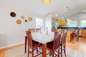 a kitchen and dining room with a table and chairs at True North in Rockaway Beach +16 photos