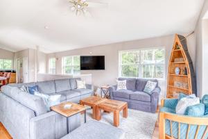 a living room with two couches and a table at True North in Rockaway Beach
