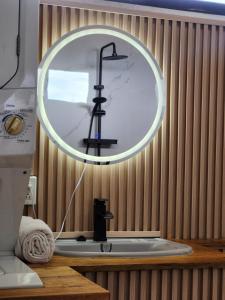 a bathroom sink with a large mirror on the wall at Tropical Breeze Apartments in Paramaribo +18 photos