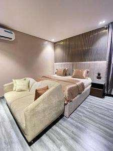a bedroom with a large bed and a couch at Calia in Lagos