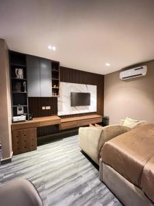 a bedroom with a bed and a flat screen tv at Calia in Lagos