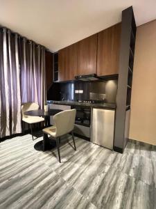 a kitchen and dining room with a table and chairs at Calia in Lagos