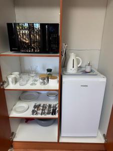 a small kitchen with a refrigerator and a microwave at Hidden Gem in George