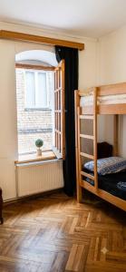 a room with two bunk beds and a window at Vintageshvili hostel and guest house in Tbilisi City