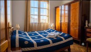 a bedroom with a bed with towels on it at Vintageshvili hostel and guest house in Tbilisi City
