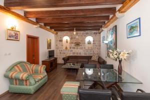 a living room with a glass table and chairs at Villa Rustica - Veslo in Begovići