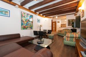 a living room with a couch and a table at Villa Rustica - Veslo in Begovići