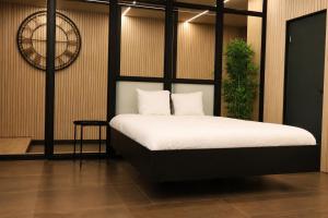 a bedroom with a bed and a plant at Wellness queen in Harzé +23 photos