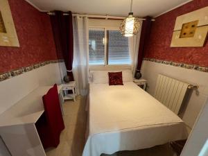 a small room with a bed and a window at Apartamento en playa arenal de Burriana in Burriana +21 photos