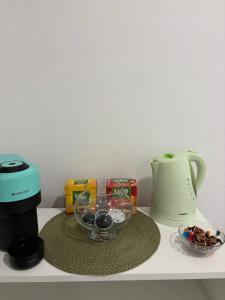 a counter with a coffee maker and a bowl of candy at Danser Residence Reșița in Reşiţa +2 photos