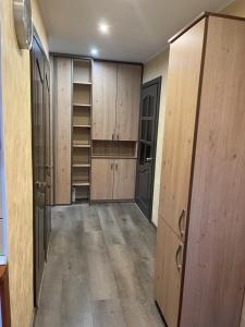 an empty locker room with wooden cabinets and shelves at Klaipeda City in Klaipėda