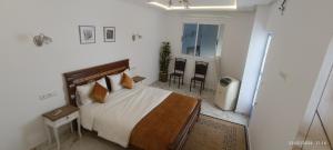 a bedroom with a bed and a television in it at Dalal house in Chefchaouen