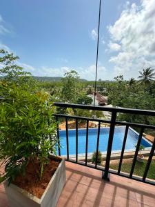 a balcony with a view of a swimming pool at Cinnamon Ridge Unawatuna in Unawatuna