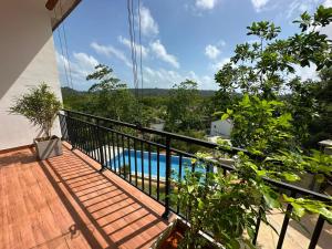 a balcony with a view of a swimming pool at Cinnamon Ridge Unawatuna in Unawatuna