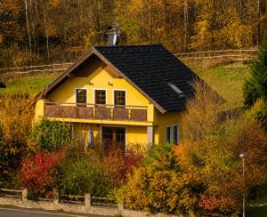 a yellow house with a black roof at Sluneční stráň - dům pro 9 osob in Dolni Dvur +26 photos