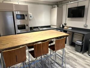 a kitchen with a large wooden table and chairs at 6Adelphi The Apartment in Preston