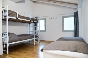 a bedroom with two bunk beds and two windows at Sottomarina Suite Palazzo Storico in Chioggia +14 photos