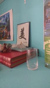 a table with two books and a glass of water at VILA LEME Casa 11 in Rio de Janeiro