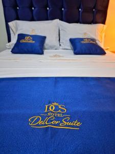 a bed with a no hotel deluxe sign on it at Delcor Suite in Piura