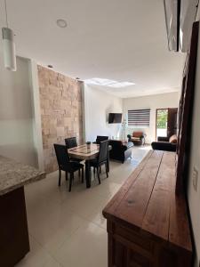 a kitchen and living room with a table and chairs at Torre Monaco en Sabalo Country in Mazatlán