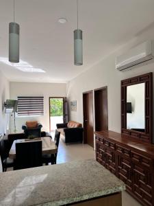 a living room with a couch and a table at Torre Monaco en Sabalo Country in Mazatlán