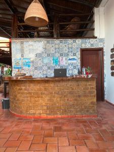 a brick bar with a laptop on a wall at Fantasia do Agreste in Jandaíra +8 photos