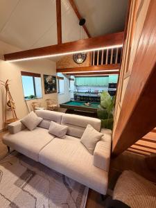 a living room with a couch and a pool table at Encantos da Aldeia - Casa da Pedra in Oliveira de Azemeis