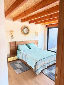 a bedroom with a bed and a window at Encantos da Aldeia - Casa da Pedra in Oliveira de Azemeis +32 photos