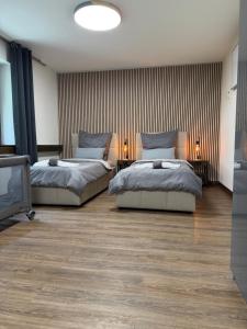 a bedroom with two beds and a tv in it at Garland-Rooms in Bremen