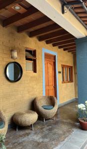 a building with two wicker chairs and a door at Sierra Norte By Chic Hotel Group in Tepoztlán +3 photos