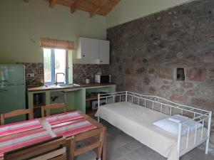 a kitchen with a bed and a table in a room at Lithos Heritage in Líkhna