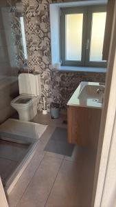 a bathroom with a toilet and a sink at Lithos Heritage in Líkhna