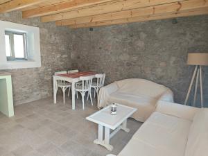 a living room with a couch and a table at Lithos Heritage in Líkhna +9 photos