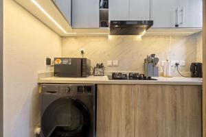 a kitchen with a washing machine on a counter at Zuma Tan in Lagos