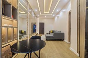 a living room with a table and a couch at Zuma Tan in Lagos