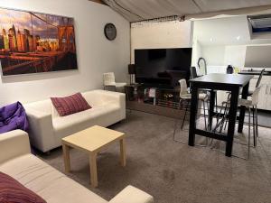 a living room with a white couch and a table at Huis krekelhof in Antwerp