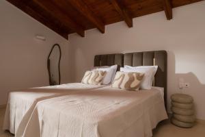 a bedroom with a large bed with white sheets and pillows at Jacomo Private Villa in Alykes