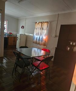 a kitchen with a table and chairs and a refrigerator at JJK free Breakfast in Barberton +11 photos