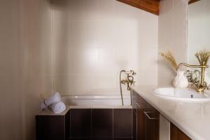 a bathroom with a bath tub and a sink at Jacomo Private Villa in Alykes +42 photos