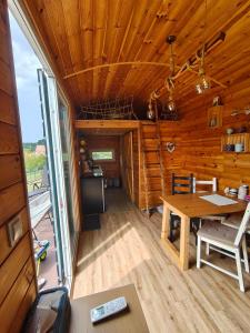 a dining room with a table in a log cabin at Slovácká maringotka in Šumice +21 photos