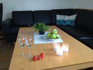 a coffee table with wine glasses and fruit on it at Mix Tana Spiseri og Overnatting in Tana