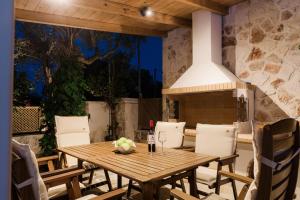 a wooden table and chairs on a patio at Jacomo Private Villa in Alykes