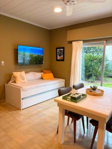 a living room with a bed and a table and a dining room at Rancho nuevo in Carhué