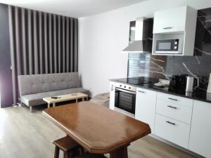 a kitchen with a table and a couch in a room at Green House in Aveiro