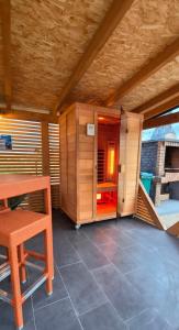 a room with a table and a bench and a room with a room at Atrijland Cazin in Cazin
